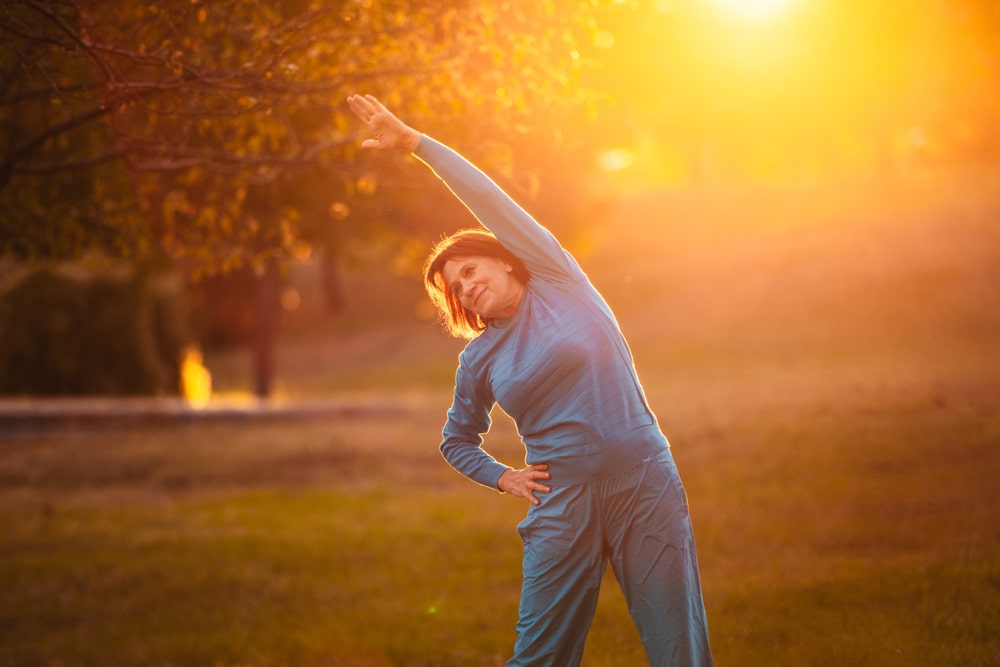 An,Elderly,Woman,Goes,In,For,Sports,At,Sunset.,Exercises
