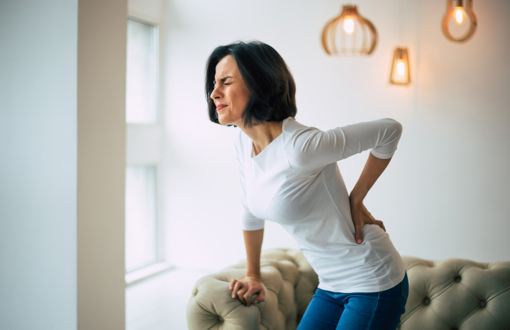 Woman holding lower back in pain may need ALIF in Palm Beach, FL Woman holding lower back in pain may need ALIF in Palm Beach, FL