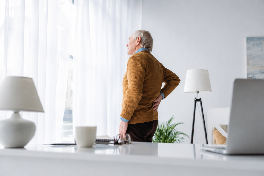 Elder man holding his back in pain Elder man holding his back in pain due to osteoporosis in Palm Beach Gardens, FL