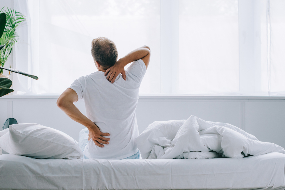 Man holding his neck due to cervical myelopathy pain.