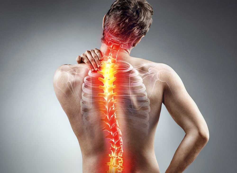 Man holding his neck and back with sciatica pain. Man holding his neck and back with sciatica pain.