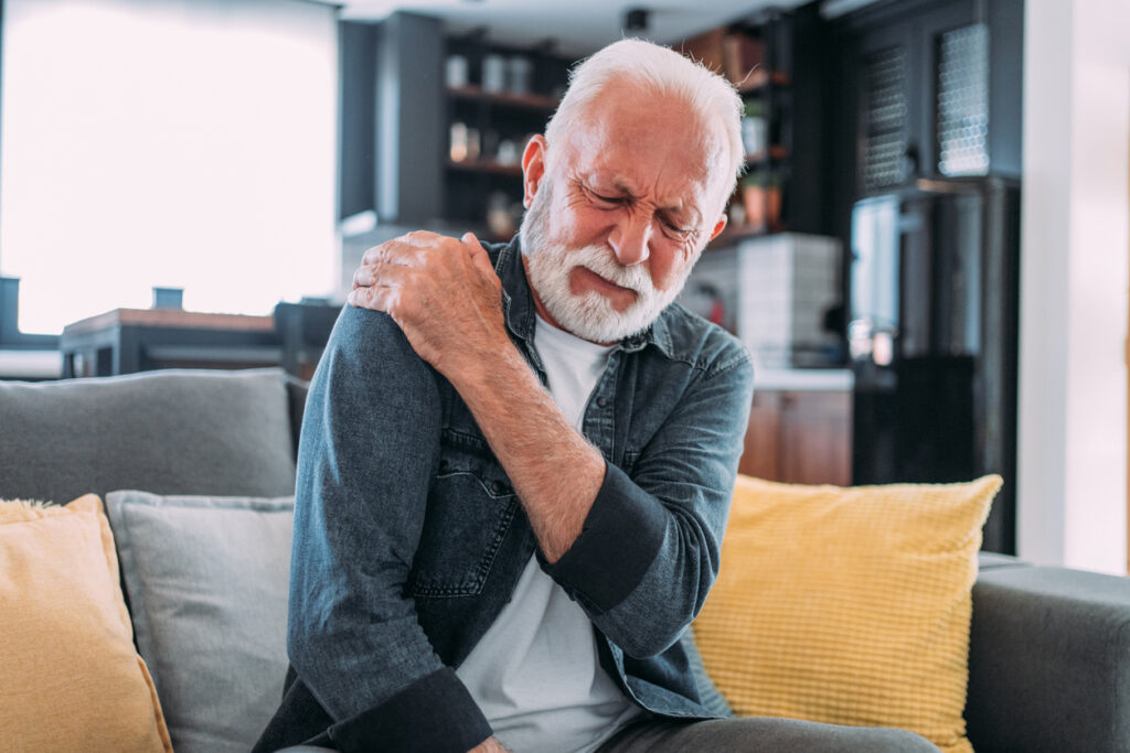 Man experiencing back pain due to a herniated disc. Man experiencing back pain due to a herniated disc.